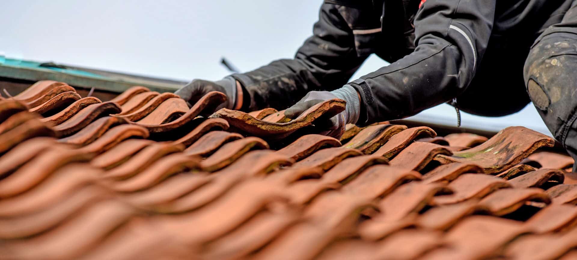 Man working on tiled roof